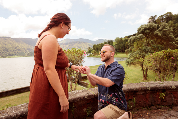 A guy on his knee proposes to his girlfriend during a surprise proposal photoshoot in the Azores