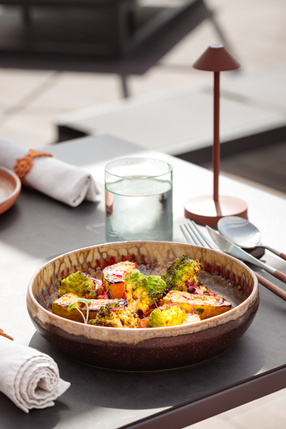A vegetable dish on an outdoor table during a food photography session in the Azores